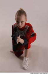 DENISA KNEELING POSE WITH GUN